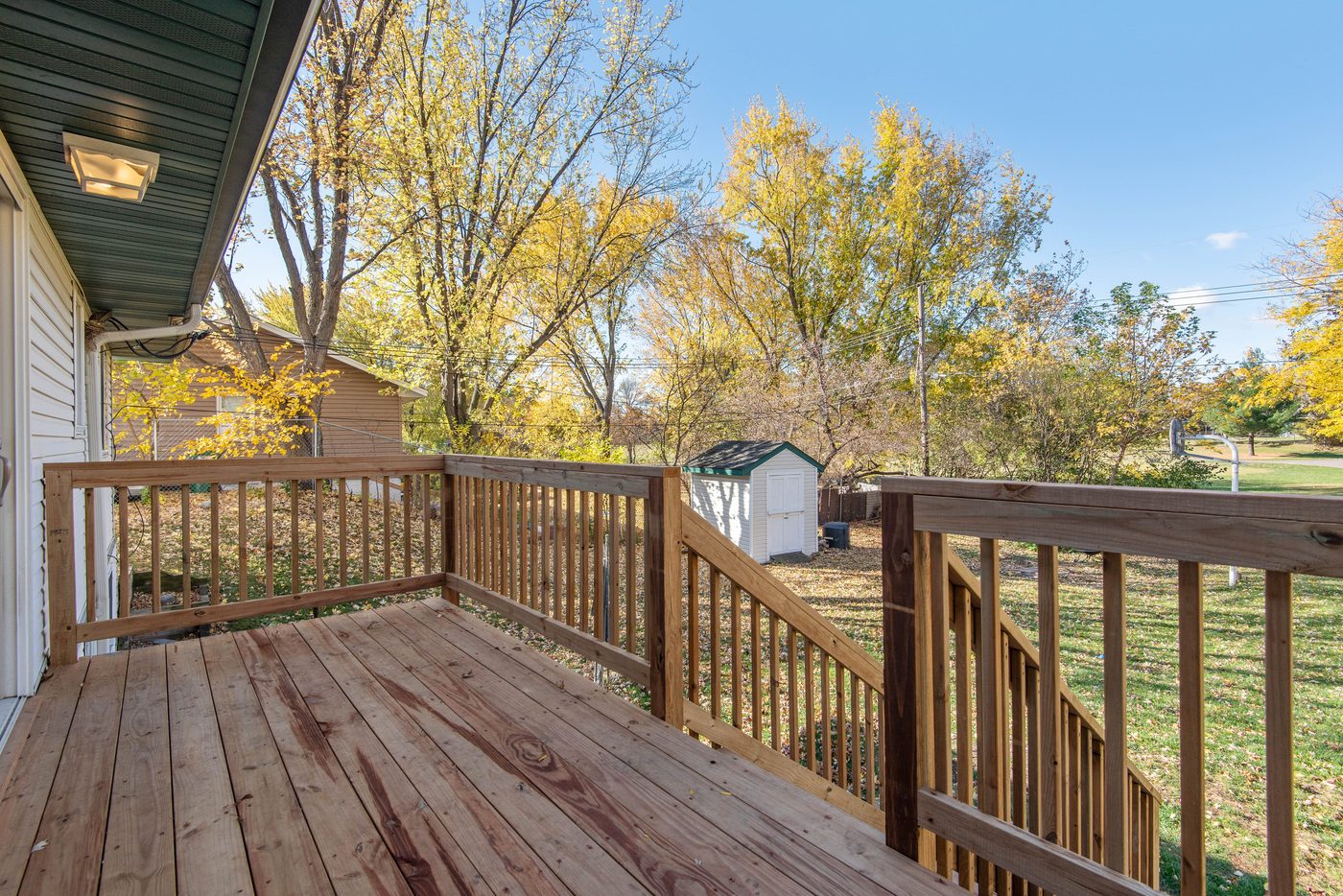 Backyard wooden deck and patio area of a residential home